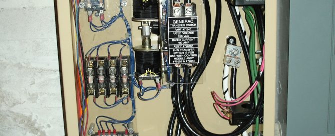 Photograph of an automatic transfer switch being repaired for a commercial generator.